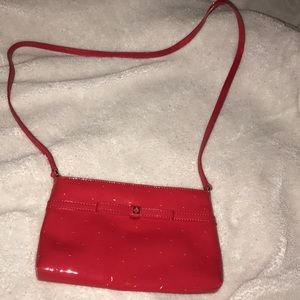 Small shiny red Kate Spade cross body purse